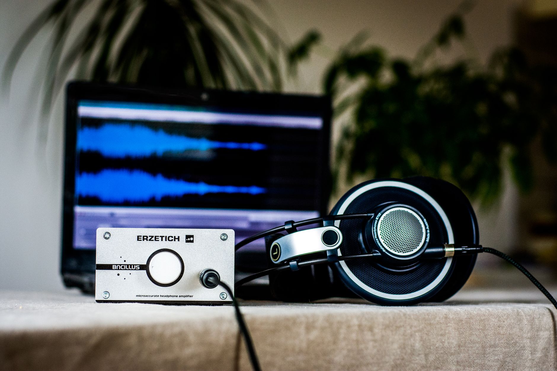 home studio desk with laptop daw software screen
