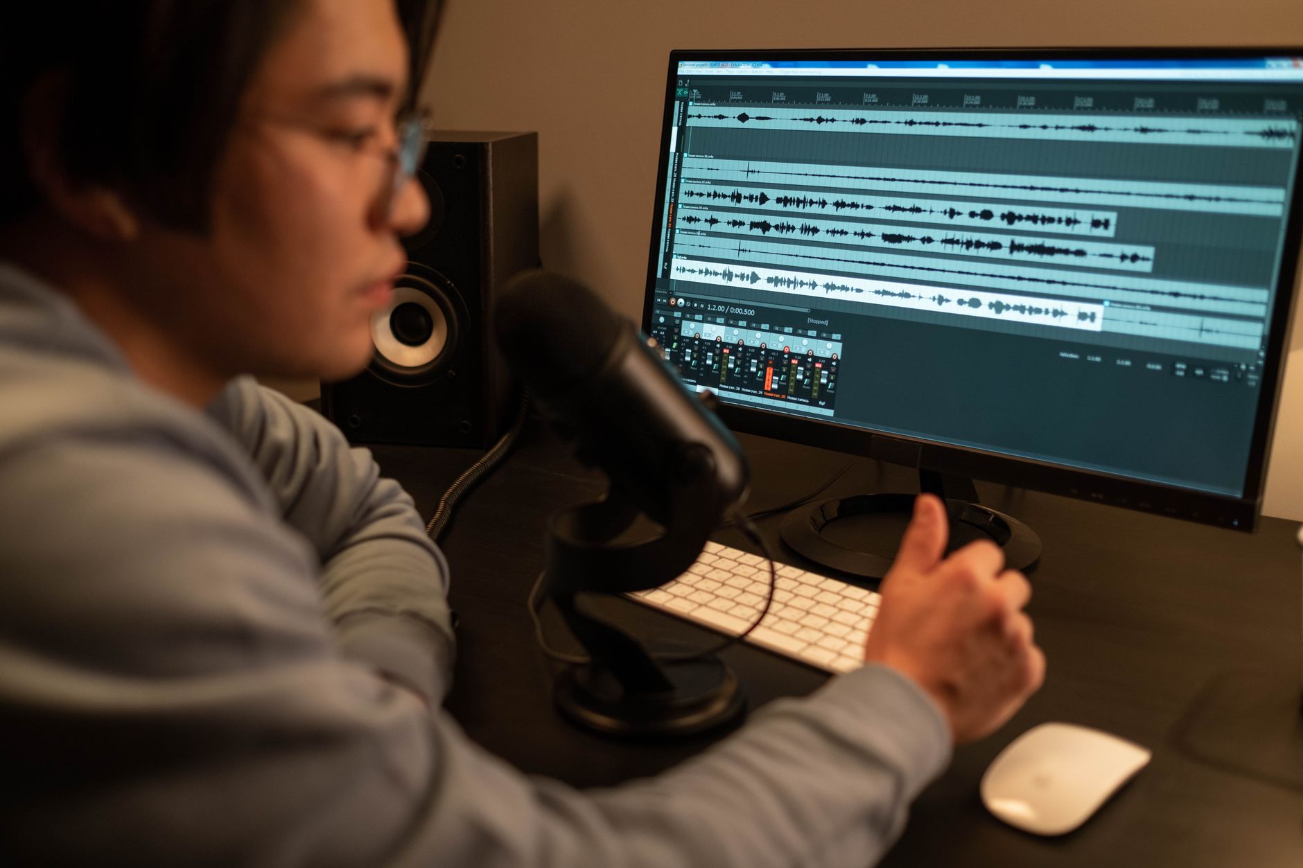 entry-level home recording studio desk setup with interface and microphone