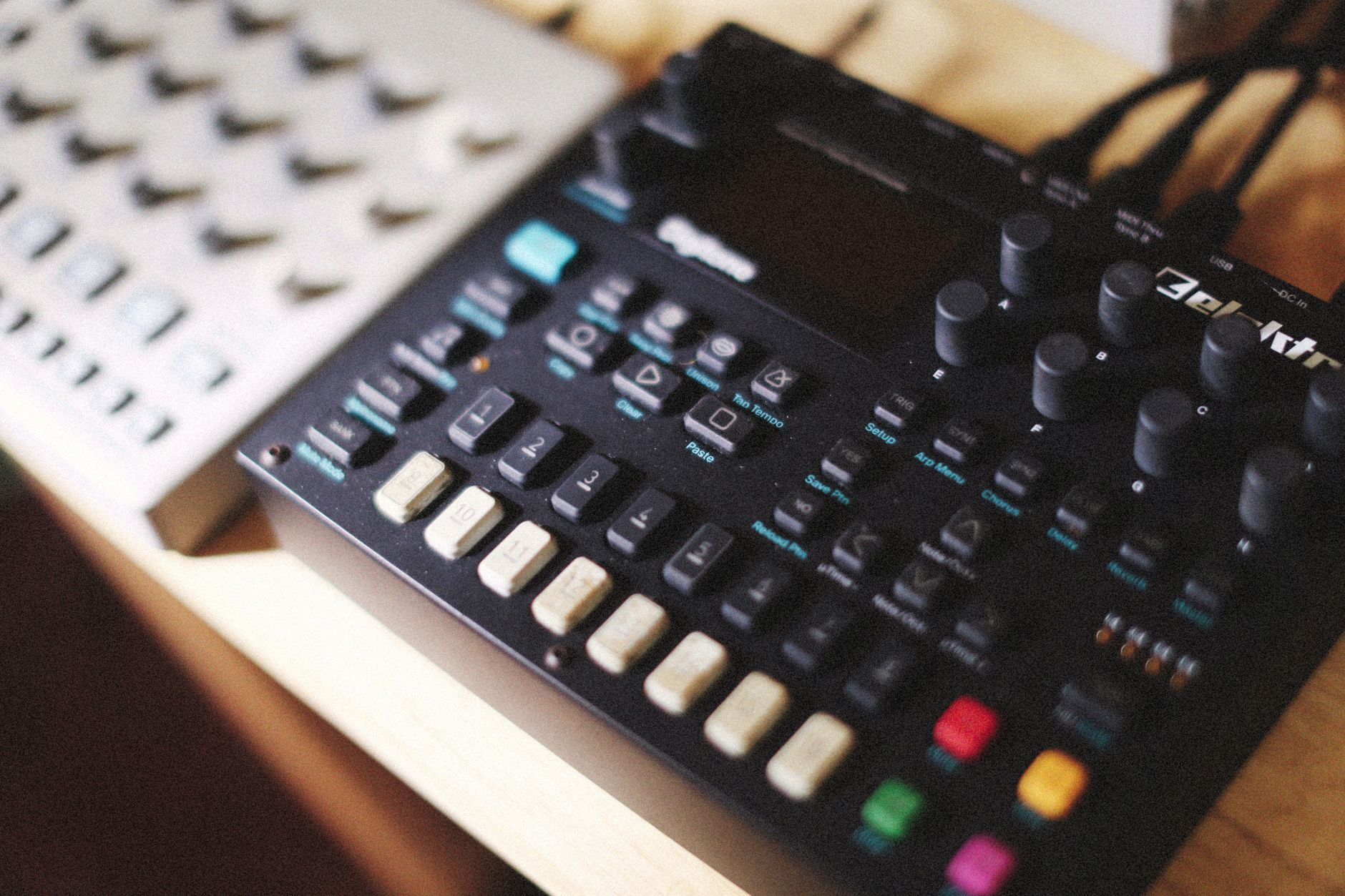 midi din cable plugged into hardware synthesizer back panel